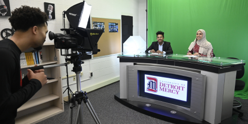 Students record in the broadcast studio.