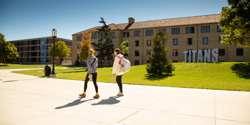 Students walk past the Titans sign on campus.