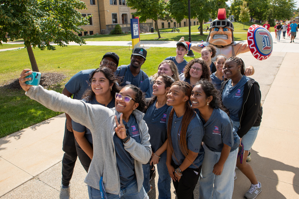 Students take a selfie with Tommy Titan.